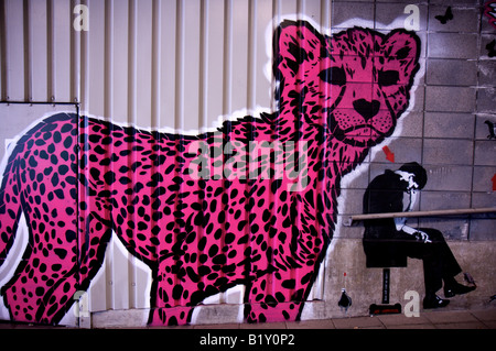 Graffiti of pink cheetah cub and man on wall of Leake Street, Waterloo, London, United Kingdom Stock Photo