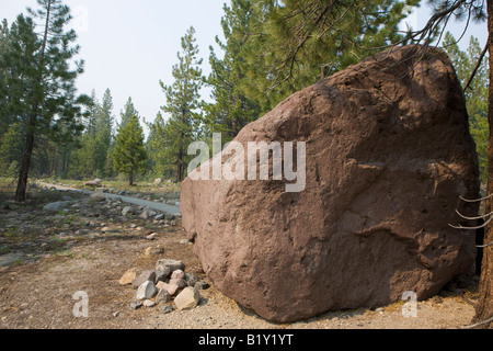 Lava boulder, moved 3 miles down hill after the 1915 eruption, was formed over 27,000 years ago, Lassen Volcanic National Park Stock Photo