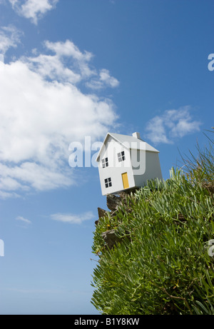 Model house on cliff edge Stock Photo