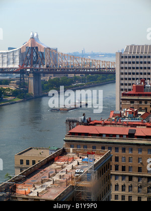 Barge floating down the East River of New York City Stock Photo