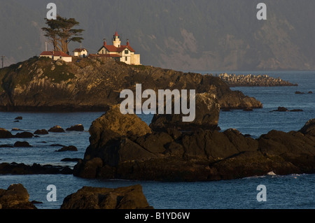 Lighthouse Trees and Rocks at Sunset in Crescent City California Stock Photo