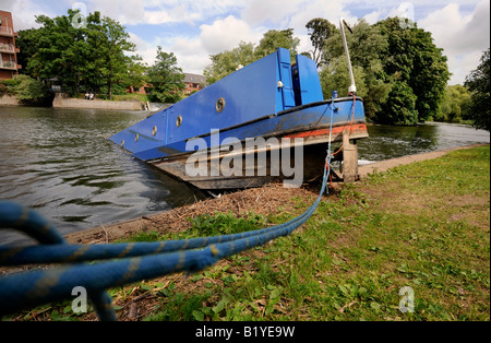 High and dry: when flood waters subsided this narrowboat at Stratford upon Avon was left stuck on the riverbank. Stock Photo