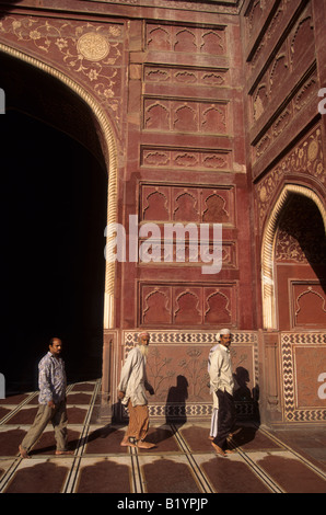 Muslims walk through a mosque on the grounds of the Taj Mahal complex in Agra India Stock Photo