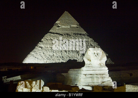 The pyramids of Giza and sphinx illuminated with lights during the sound and light show in Cairo Egypt Stock Photo