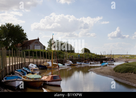 Small boats moored on a tidal creek on the river Glaven at Blakeney, North Norfolk Coast Stock Photo