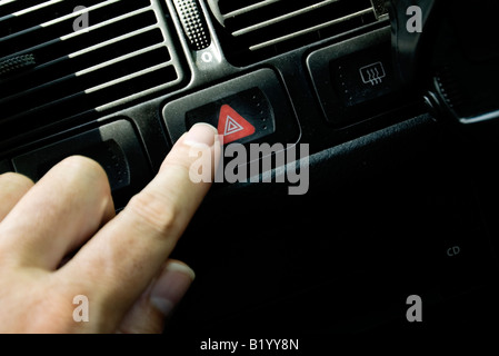 pushing hazard button in car Stock Photo