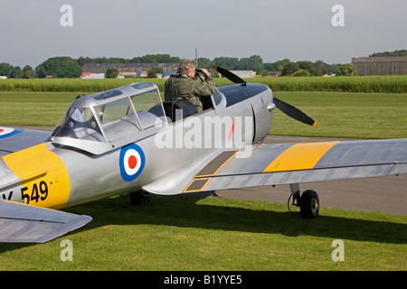 DeHavilland (Canada) DHC-1 Chipmunk 22 WK549 G-BTWF on the flight line at Breighton Airfield with pilot getting into cockpit Stock Photo