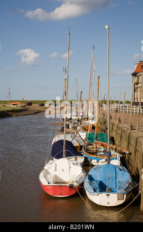 Small yachts and boats moored on the waterfront at the River Glaven at Blakeney Harbour, North Norfolk Coast Stock Photo