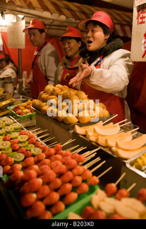 Stall selling candied fruit sticks in the Night Market Wangfujing Street Beijing China Stock Photo