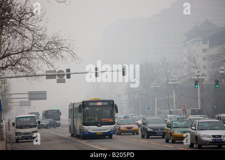 Coach and heavy traffic in air pollution smog on Beijing main street Chang An Avenue China Stock Photo