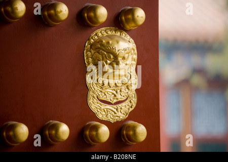 Nails and lion head knocker on gate to Tower of Buddhist Incense at The Summer Palace Beijing China Stock Photo