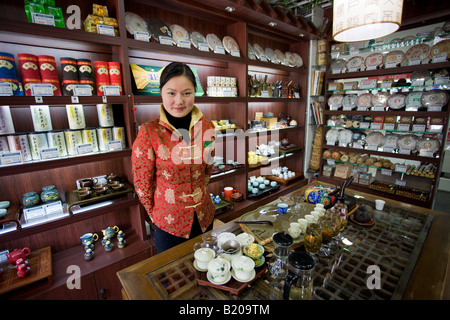 Woman working in tea shop near the Yu Garden Bazaar Market Shanghai China Stock Photo