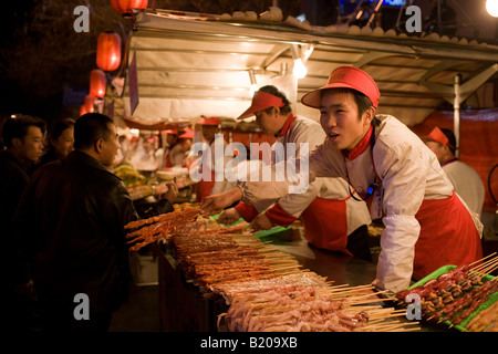 Stall selling meat kebabs in the Night Market Wangfujing Street Beijing China Stock Photo