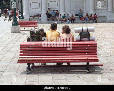 young couple travellers with rucksacks in street in venice, italy Stock Photo