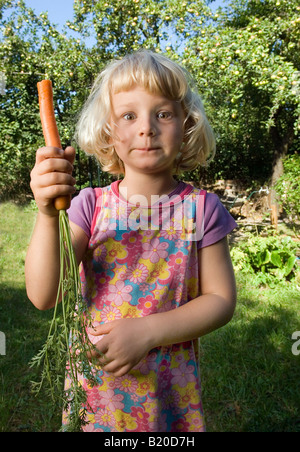 Kid eating a carrot Stock Photo