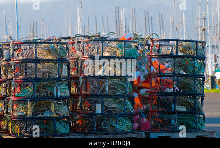 Stacks of crab traps and fishing gear on docks Stock Photo