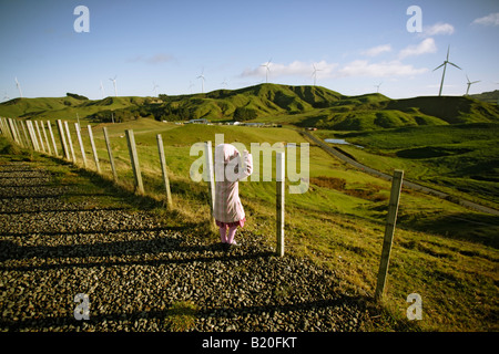 Girl explores a windmill open to visitors at Te Apiti windfarm near Palmerston North Manawatu New Zealand Stock Photo