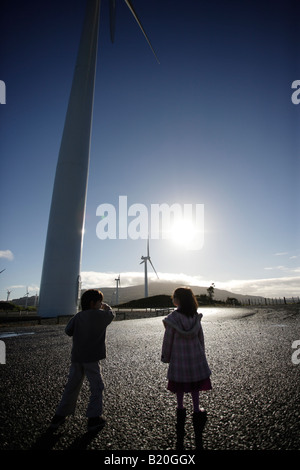 Boy aged six and sister four visit modern wind turbines Te Apiti windfarm near Palmerston North Manawatu New Zealand Stock Photo