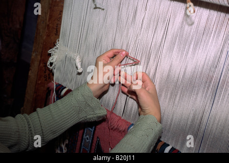 Turkey, Anatolia, Cappadocia, Göreme, carpet weaving, loom and hands close up Stock Photo