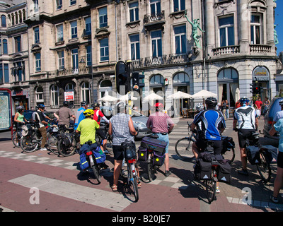 Group of bicyclists waiting to cross the street in the city center of Antwer Flanders Belgium Stock Photo