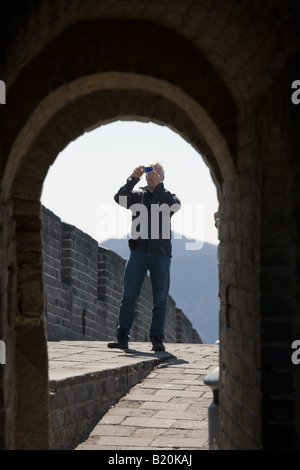 Tourist takes a photograph on The Great Wall of China at Mutianyu north of Beijing