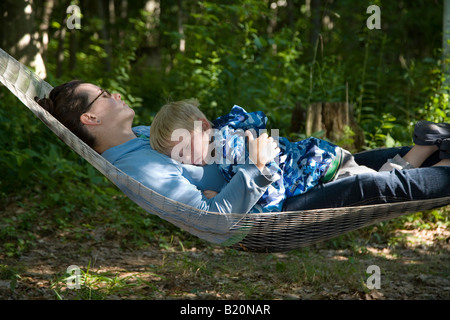 Prairieville Michigan A two year old boy sleeps with his mother on a hammock Stock Photo