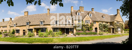 A panoramic view of old stone cottages in the High Street in the Cotswold village of Broadway, Worcestershire Stock Photo