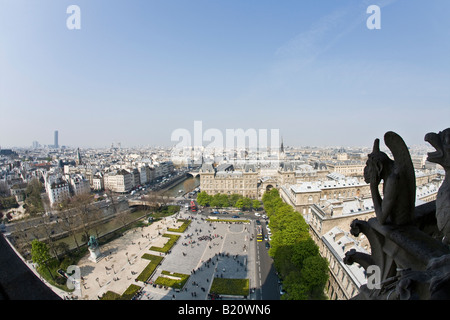 Notre Dame Cathedral gargoyles on exterior with scenic panoramic view over Paris in spring sunshine France Europe EU Stock Photo