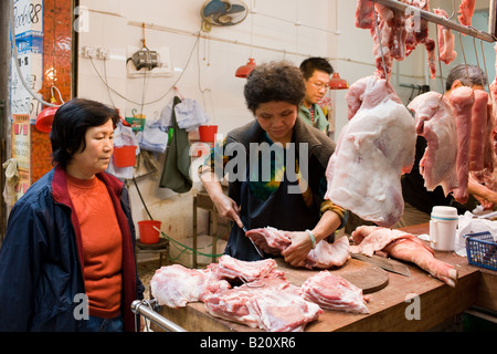 Fresh meat on sale in butcher shop in old Chinese Soho food market in Graham Street Hong Kong China Stock Photo