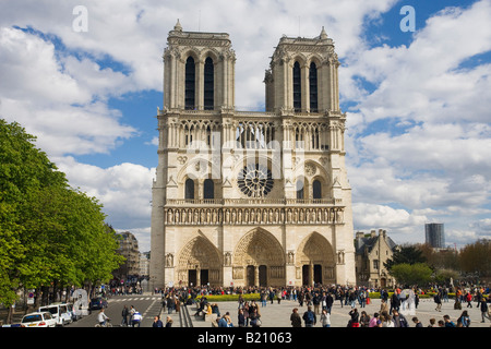 Notre Dame Cathedral exterior west entrance facade with visitors and tourists in spring sunshine Paris France Europe Stock Photo