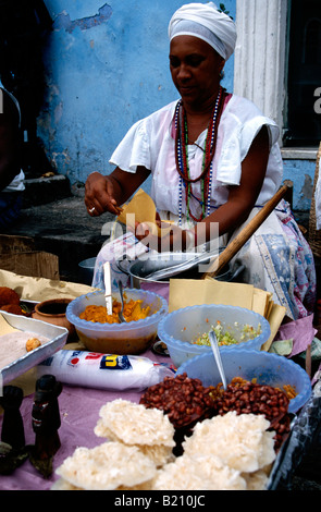 Baiana in traditional dress cooking Acaraje on Largo de Pelourinho Salvador de Bahia Brazil Stock Photo