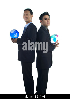 2 Business Man Back to Back each holding a globe Stock Photo