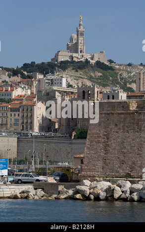 View of Marseilles harbour looking from the harbour entrance back towards Notre Dame de la Garde Cathedral on the hill. Stock Photo