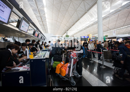 Passengers at check in desks Hong Kong International Airport China Stock Photo