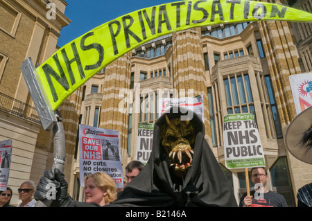 Grim Reaper and placards at London Keep our NHS Public demo on 60th anniversary of NHS outside Richmond House, Whitehall NHS HQ Stock Photo