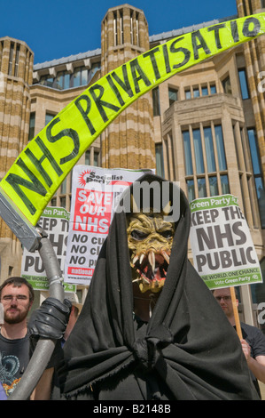 Grim Reaper and placards at London Keep our NHS Public demo on 60th anniversary of NHS outside Richmond House, Whitehall NHS HQ Stock Photo