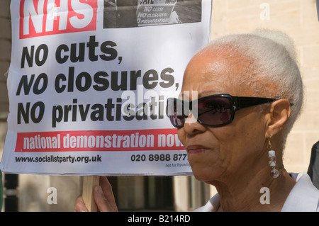 Black woman and placard at London Keep our NHS Public demo on 60th anniversary of NHS outside Richmond House, Whitehall NHS HQ Stock Photo