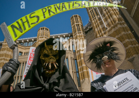 Grim Reaper and Fat Cat at London Keep our NHS Public demo on 60th anniversary of NHS outside Richmond House, Whitehall NHS HQ Stock Photo