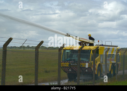 Airport Fire Truck demonstrating fire fighting capabilities at East Midlands Airport Derbyshire England Stock Photo