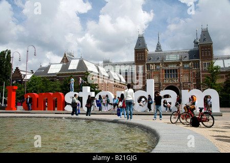 editorial tourists playing on i amsterdam sign in front of rijksmuseum amsterdam holland Stock Photo