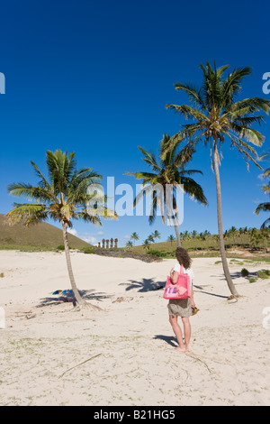 South America Chile Rapa Nui Isla de Pascua Easter Island Anakena beach woman looking at the giant stone Moai statues of Ahu Nau Stock Photo