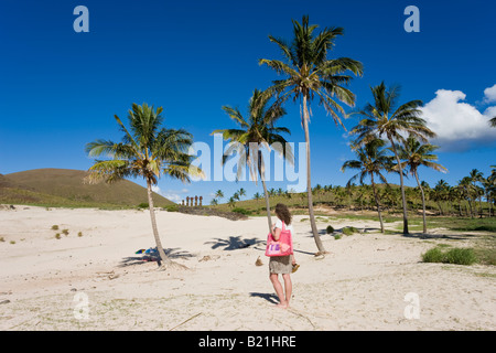 South America Chile Rapa Nui Isla de Pascua Easter Island Anakena beach woman looking at the giant stone Moai statues of Ahu Nau Stock Photo