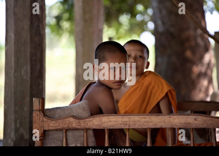 Young Buddhist monks relaxing in the shade, Mekong region, southern Laos Stock Photo