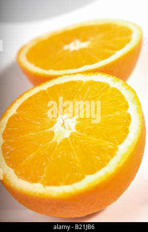 Cut orange arranged on a white background Stock Photo