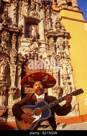 street musician plays a guitar in front of the Church of San Diego Guanajuato Mexico Stock Photo