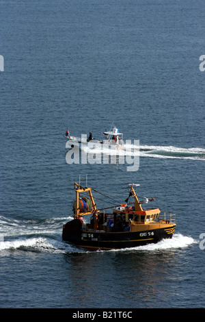 Boats coming and going in the English Channel close to Cherbourg harbour Stock Photo