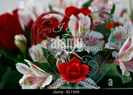 A bouquet of red roses with a heart of glass for the Valentines Day pictures images photos photograph from above horizontal in USA US hi-res Stock Photo