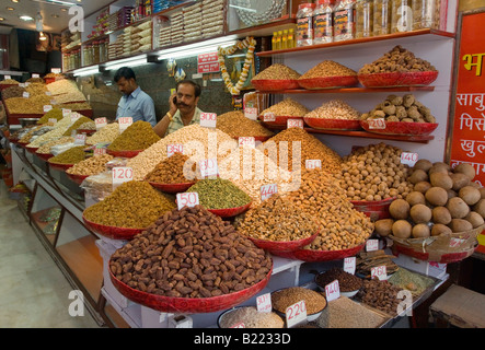 INDIAN MERCHANTS sell spices and dried fruit in the SPICE MARKET of CHANDNI CHOWK OLD DELHI INDIA Stock Photo
