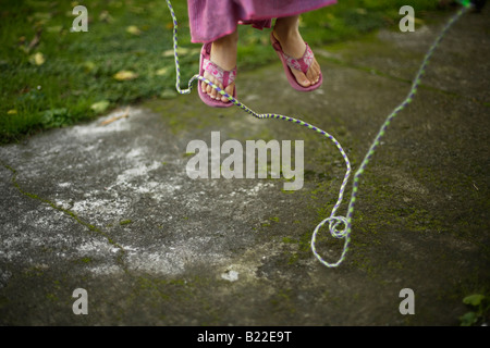 Girl aged four learning to skip Stock Photo