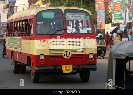 Ashok Leyland bus travels through heavy traffic at sunset in Thiruvananthapuram Kerala India Stock Photo